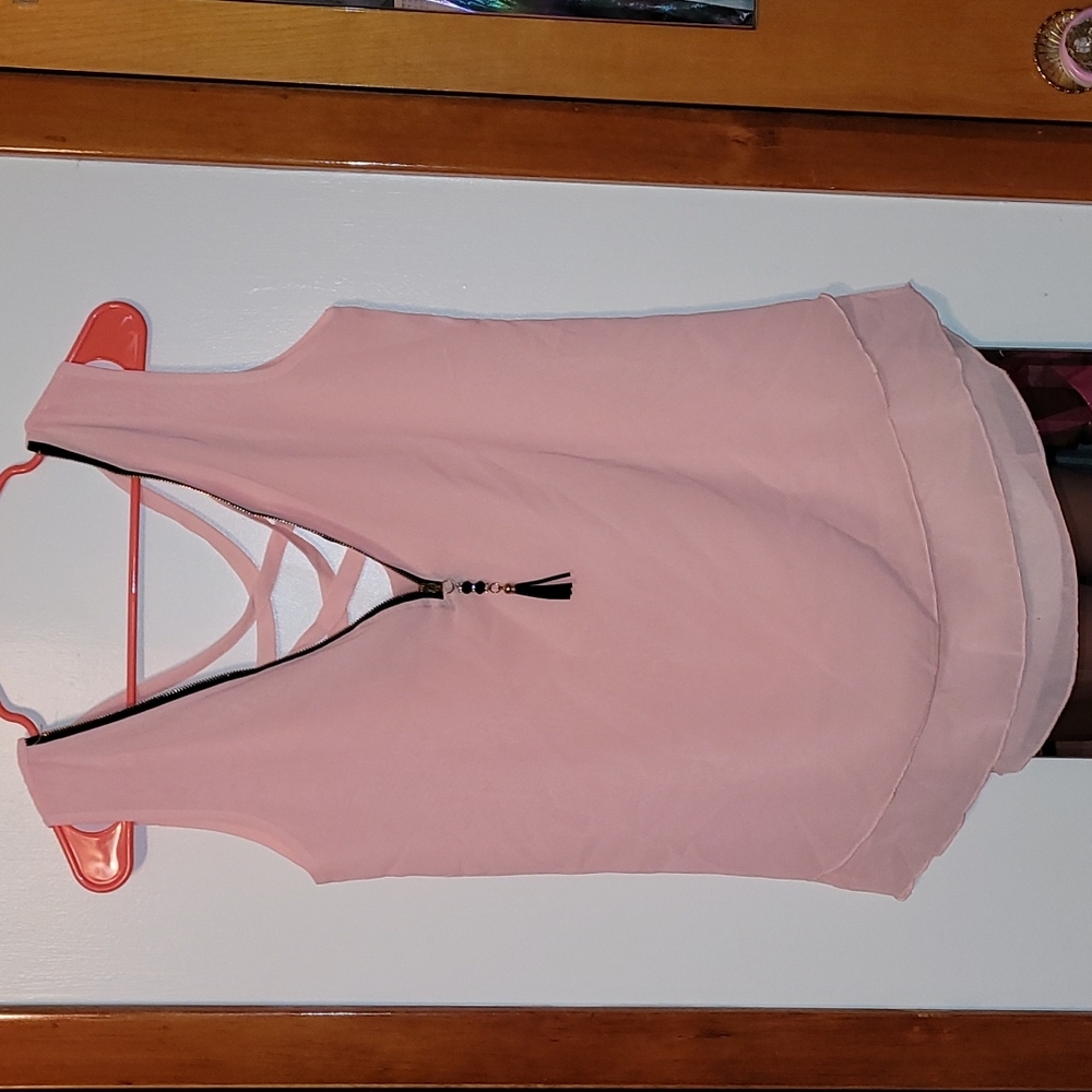 Light pink sleeveless top, size M, zipper in front and cute criss cross in back